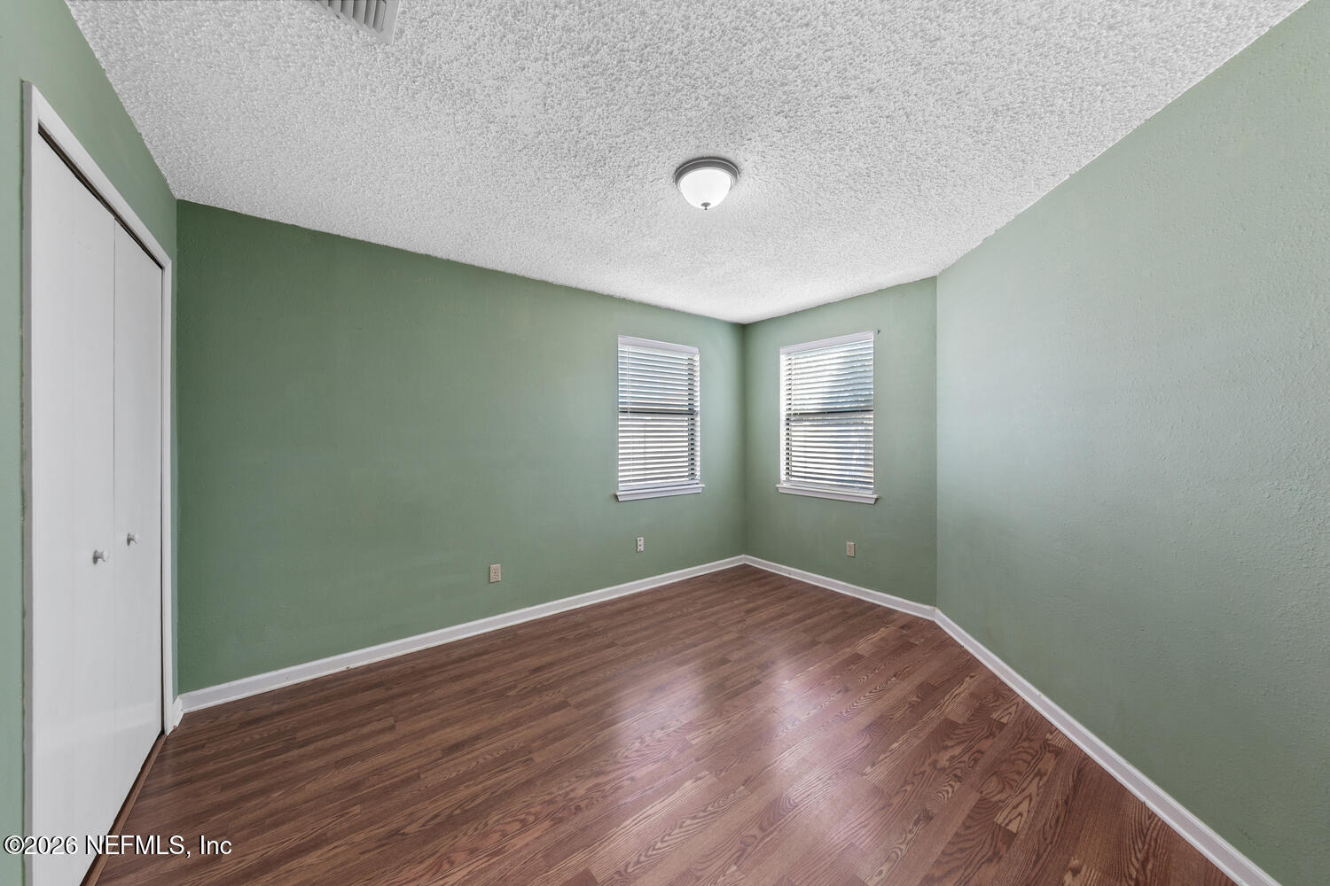 494 Filmore Drive Jacksonville, FL 32225 - Photo 20 of 25 an empty room with wooden floor and windows