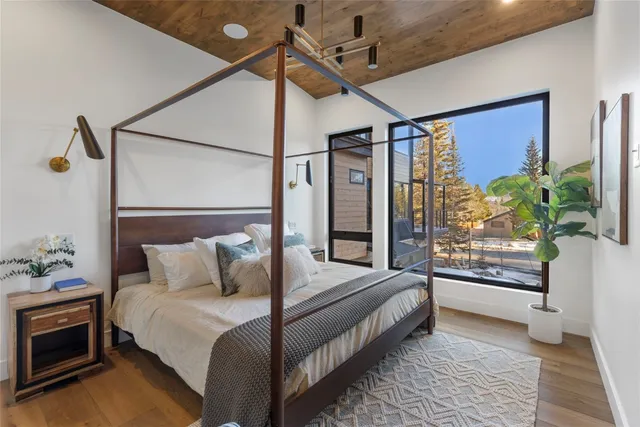 a bedroom with double bed and a potted plant