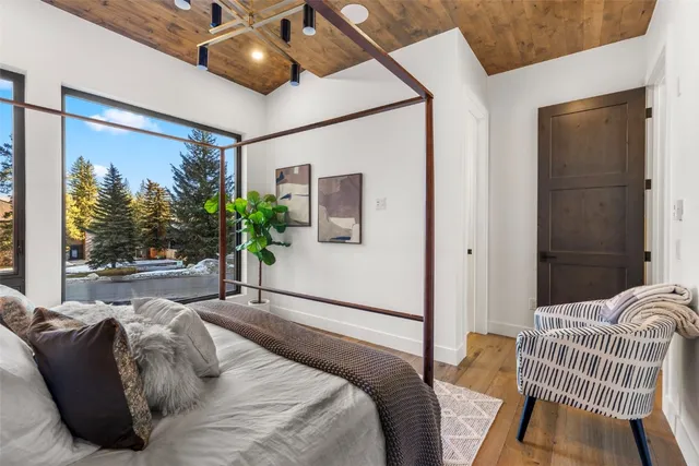 a bedroom with a bed window and potted plant