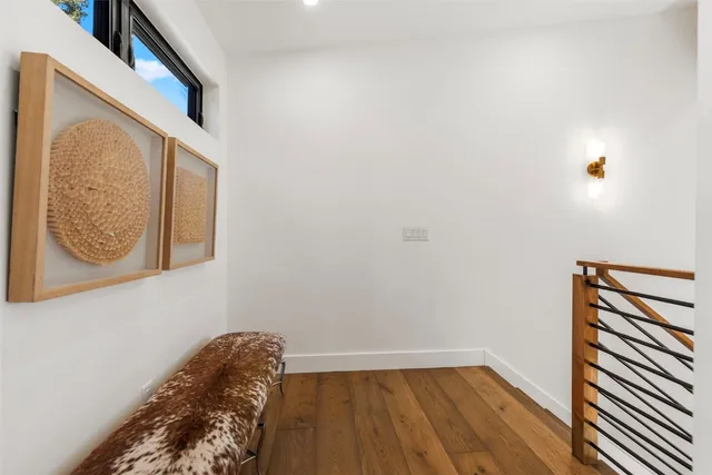 a view of a small space with wooden floor and a window
