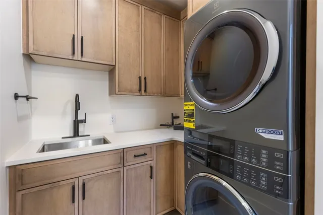 a utility room with sink dryer and washer