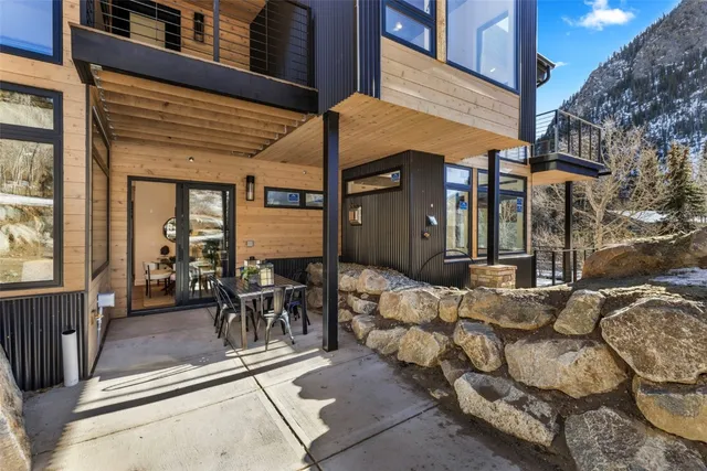 a view of a patio with couches table and chairs and floor to ceiling window