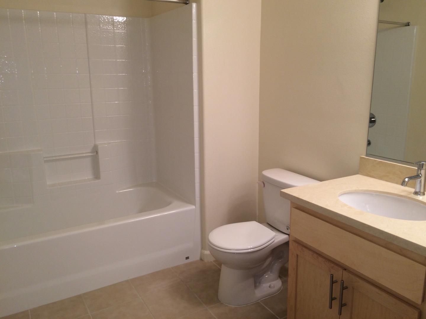 695 Elderberry Drive Milpitas, CA 95035 - Photo 12 of 22 a white toilet sitting next to a bath tub