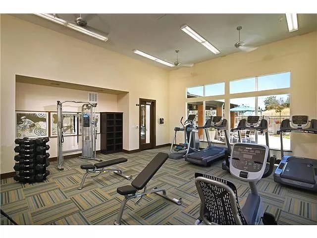 695 Elderberry Drive Milpitas, CA 95035 - Photo 4 of 22 a living room with lots of furniture and gym equipment