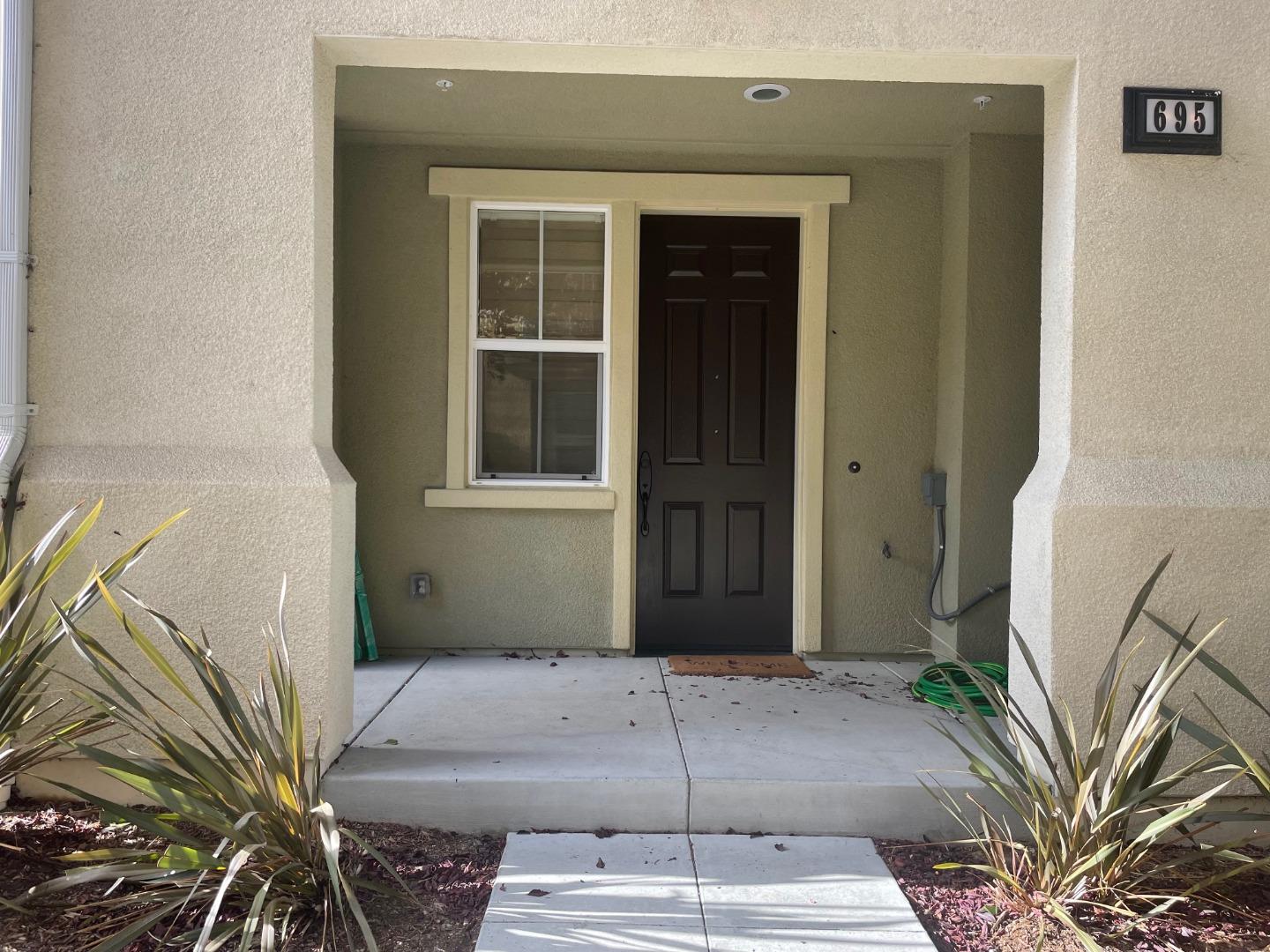 695 Elderberry Drive Milpitas, CA 95035 - Photo 5 of 22 a front view of a house with a garden