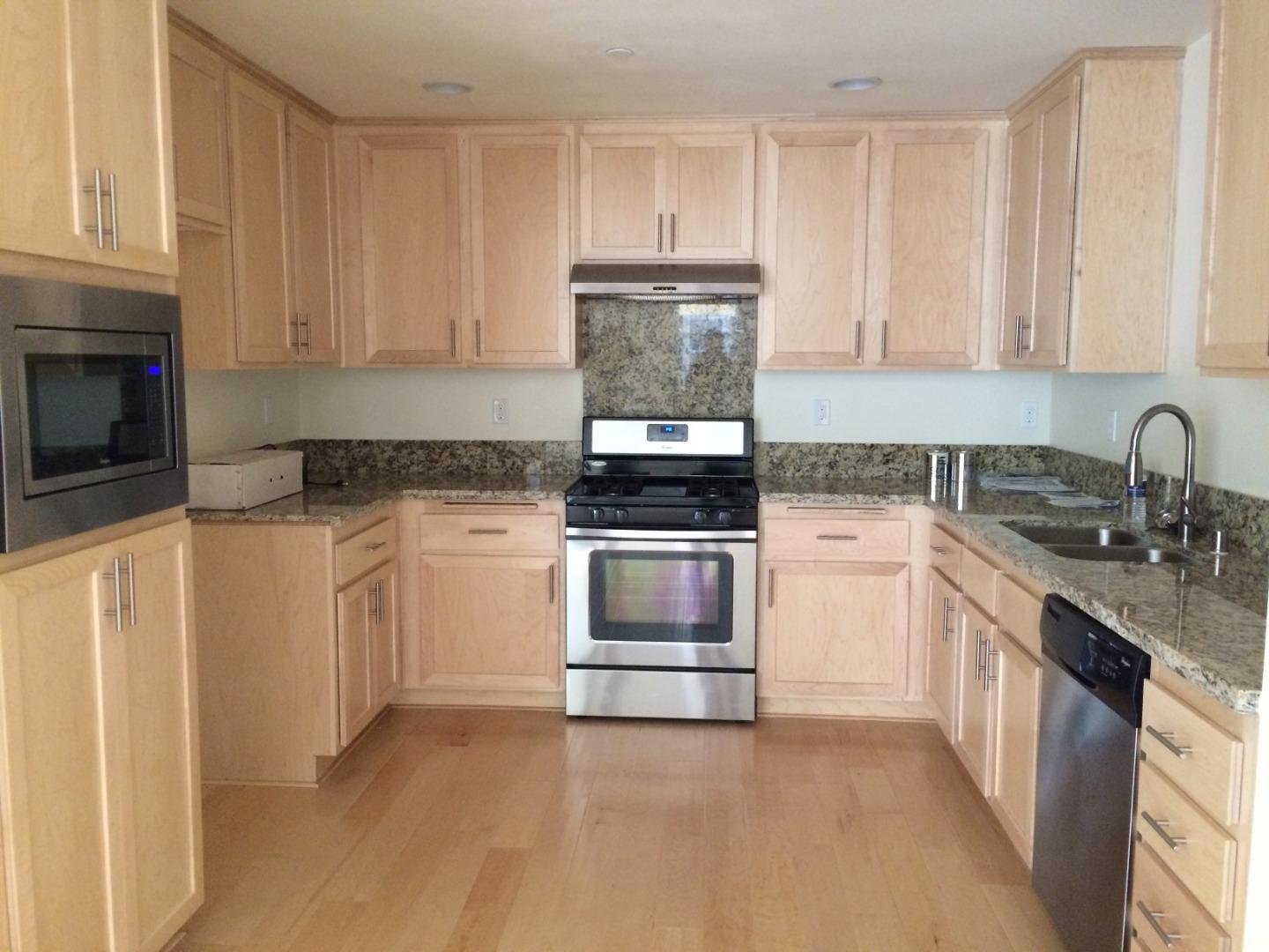695 Elderberry Drive Milpitas, CA 95035 - Photo 8 of 22 a kitchen with granite countertop white cabinets and white appliances