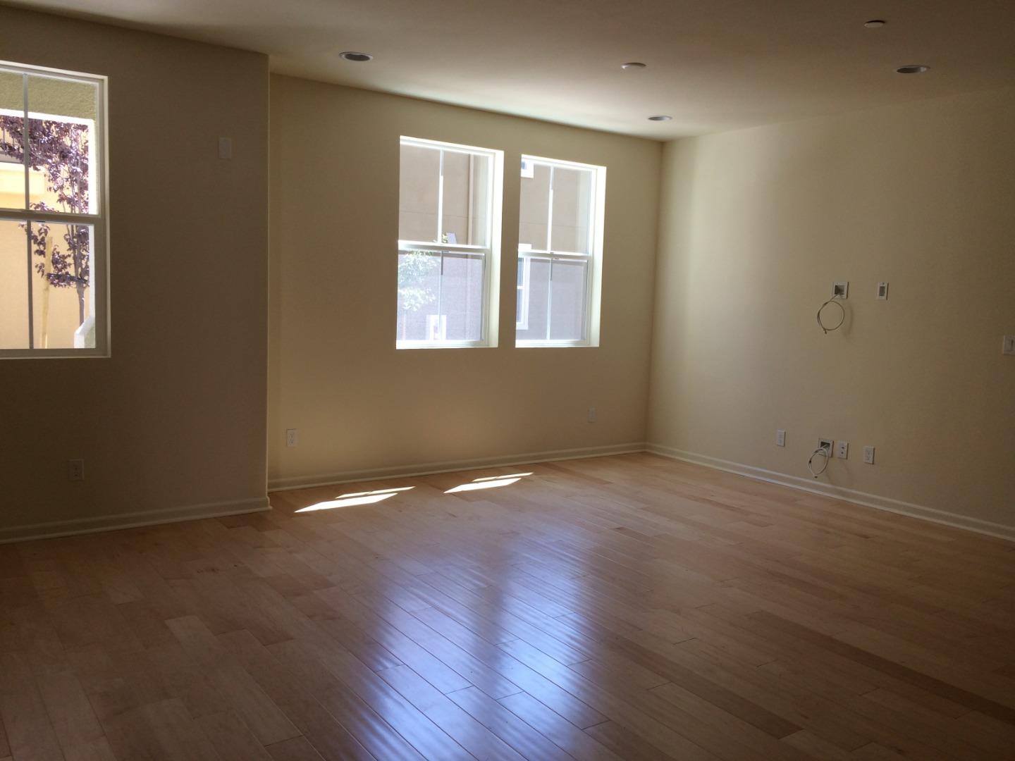 695 Elderberry Drive Milpitas, CA 95035 - Photo 10 of 22 an empty room with wooden floor and windows
