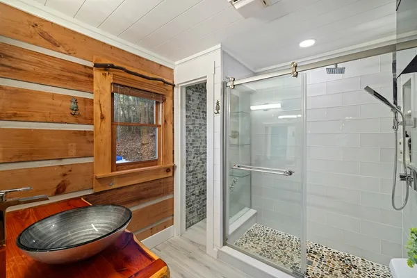 a bathroom with a shower and a sink