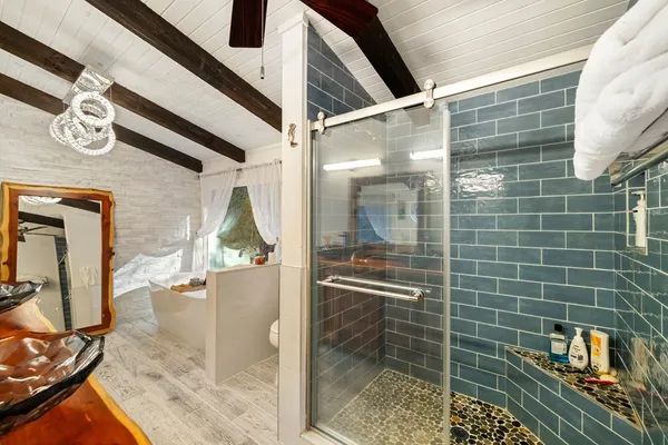 a bathroom with a bathtub and shower