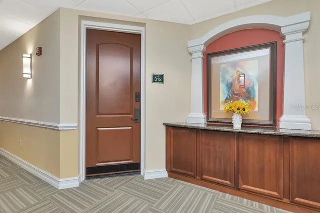 a view of a hallway with wooden floor and a hallway