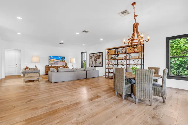 a living room with furniture a couch and a floor to ceiling window