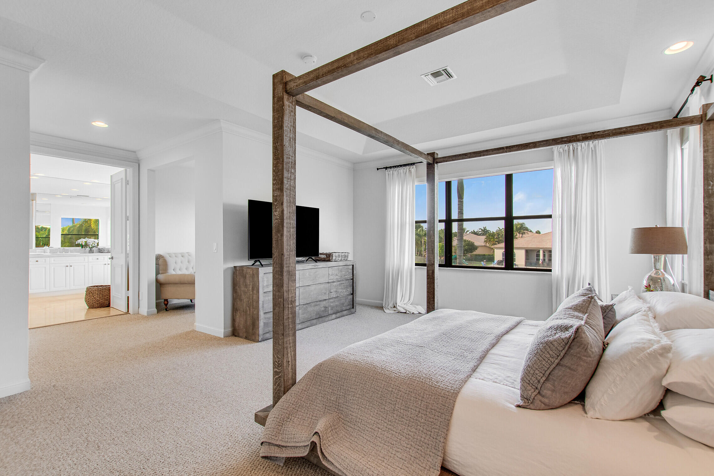 11663 Sunrise View Lane Wellington, FL 33449 - Photo 24 of 43 a bedroom with a bed and a flat screen tv