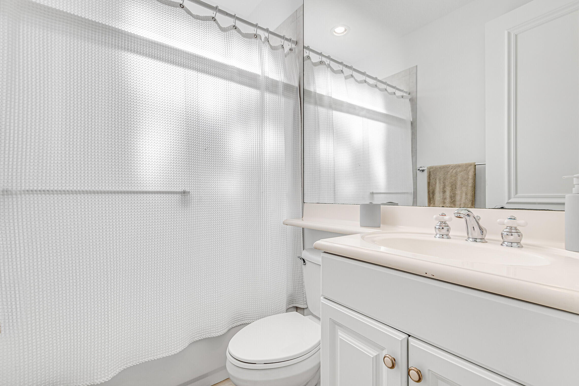 11663 Sunrise View Lane Wellington, FL 33449 - Photo 32 of 43 a bathroom with a sink a toilet and a mirror