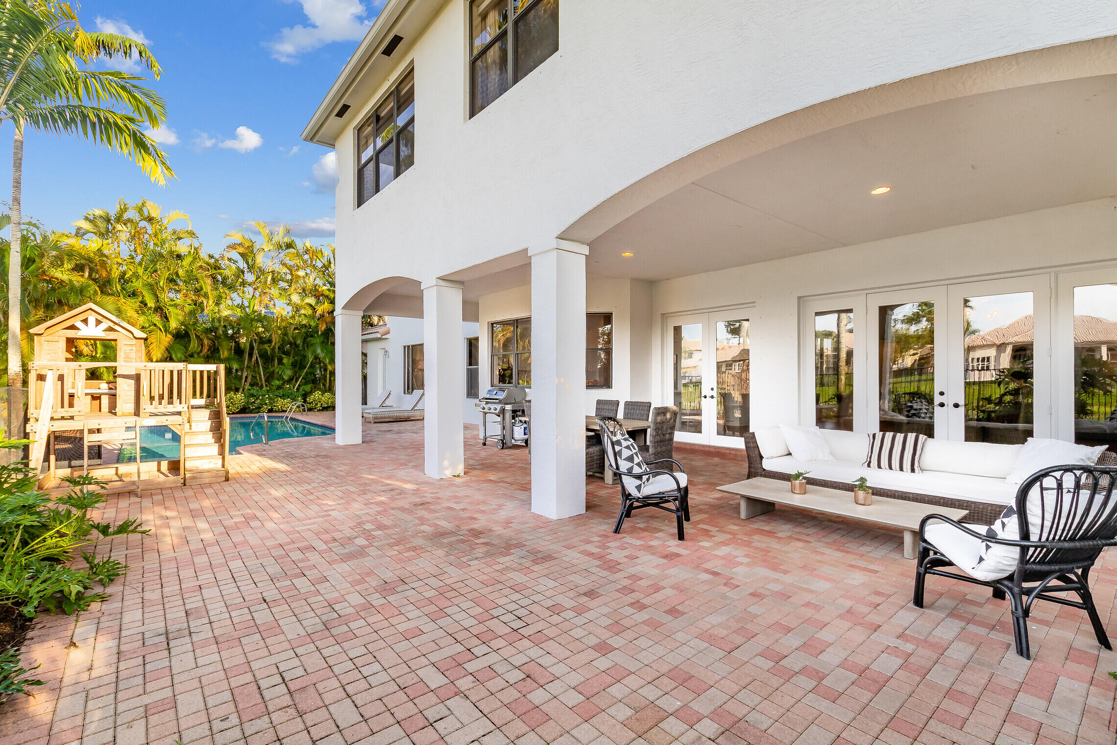 11663 Sunrise View Lane Wellington, FL 33449 - Photo 35 of 43 a living room with furniture and a floor to ceiling window
