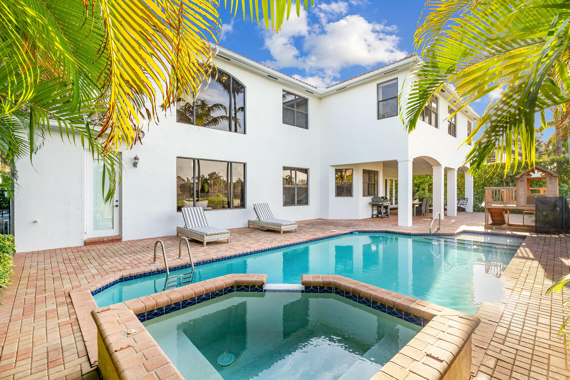 11663 Sunrise View Lane Wellington, FL 33449 - Photo 37 of 43 a view of a house with swimming pool and sitting area