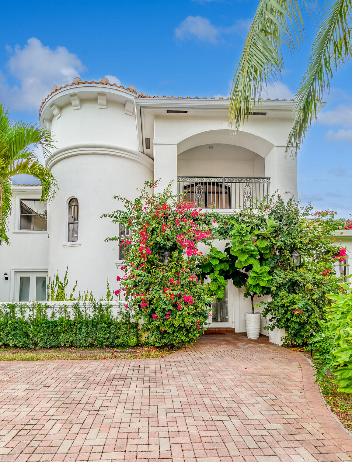 11663 Sunrise View Lane Wellington, FL 33449 - Photo 5 of 43 a view of a white house with a flower garden and a chair