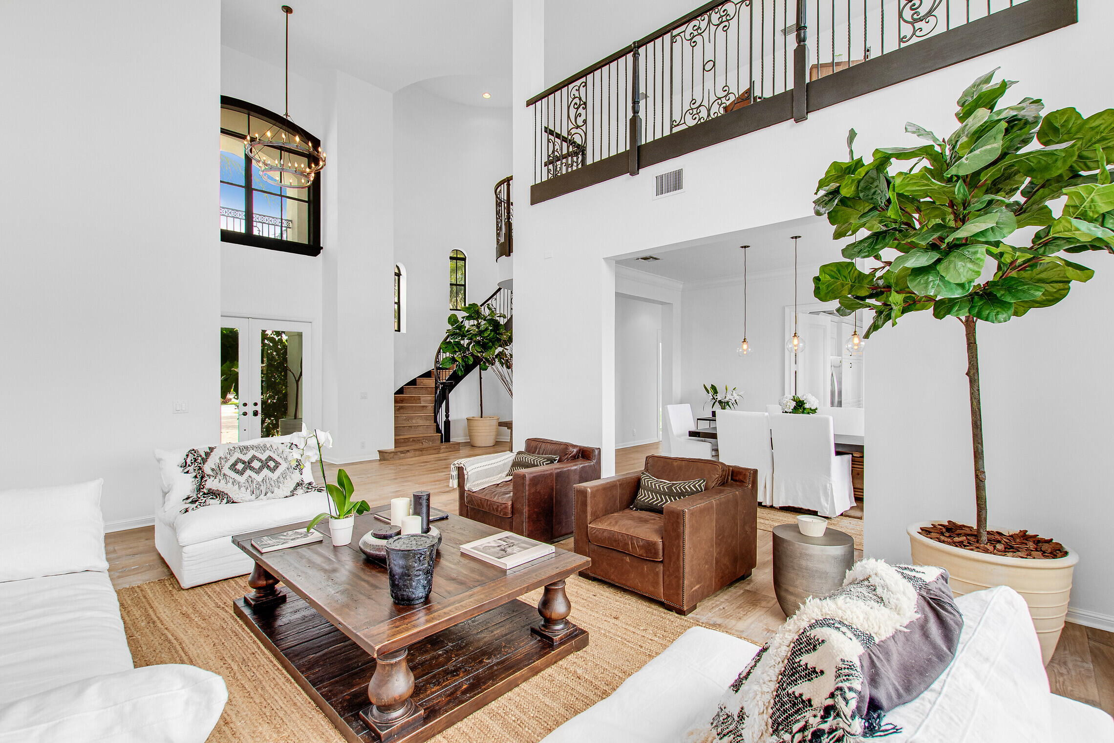 11663 Sunrise View Lane Wellington, FL 33449 - Photo 8 of 43 a living room with furniture a chandelier and a potted plant