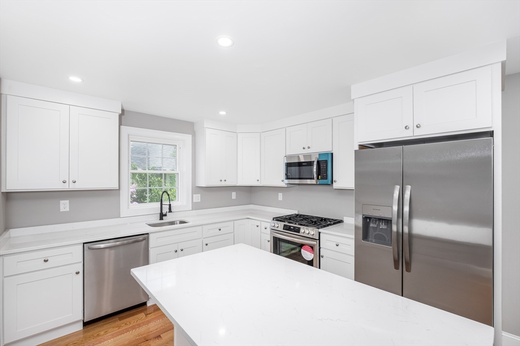 216 Vane Street, Unit 2 Revere, MA 02151 - Photo 1 of 22 a kitchen with a refrigerator a sink cabinets and a window