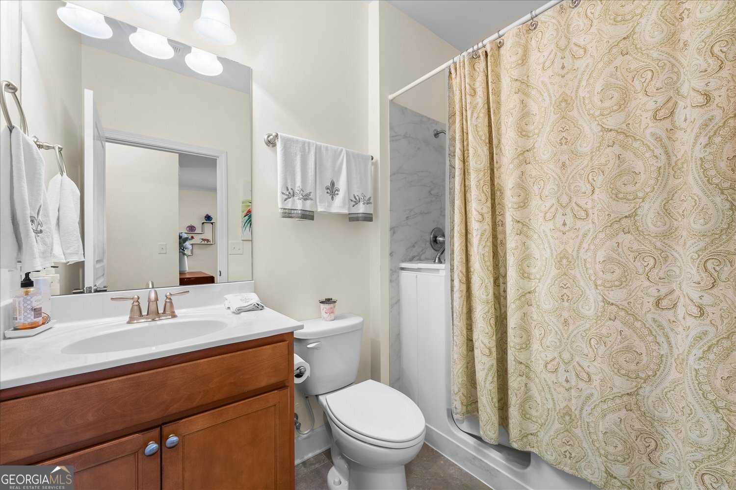 1071 Southern Pne Road Greensboro, GA 30642 - Photo 11 of 48 a bathroom with a sink a toilet a mirror and shower curtain