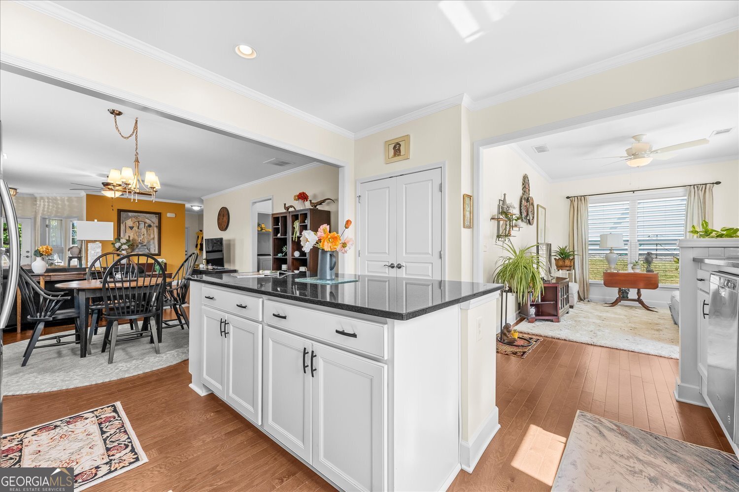1071 Southern Pne Road Greensboro, GA 30642 - Photo 25 of 48 a kitchen with stainless steel appliances granite countertop sink stove dining table and chairs