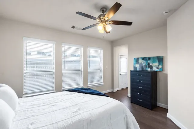 a bedroom with a bed and a window