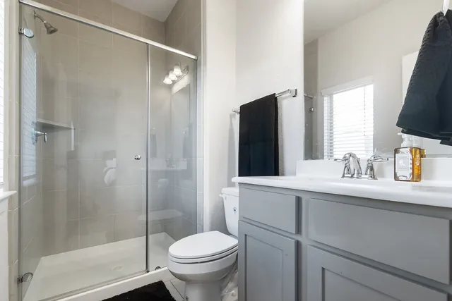 a bathroom with a sink toilet and shower