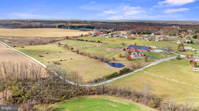 a living room with furniture a clock on wall and a large window
