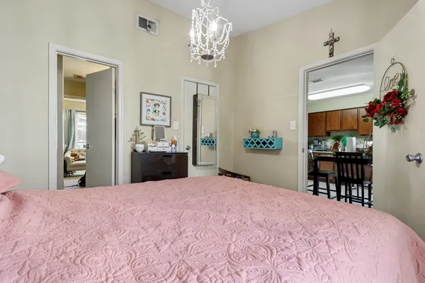 a bedroom with a bed and a dresser in it