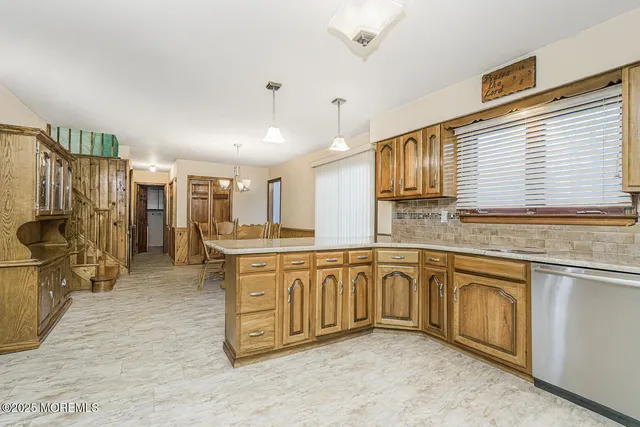 a kitchen with stainless steel appliances granite countertop a sink and cabinets