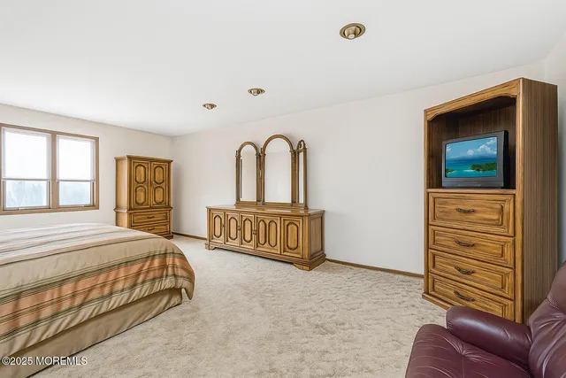 a bedroom with a bed and dresser