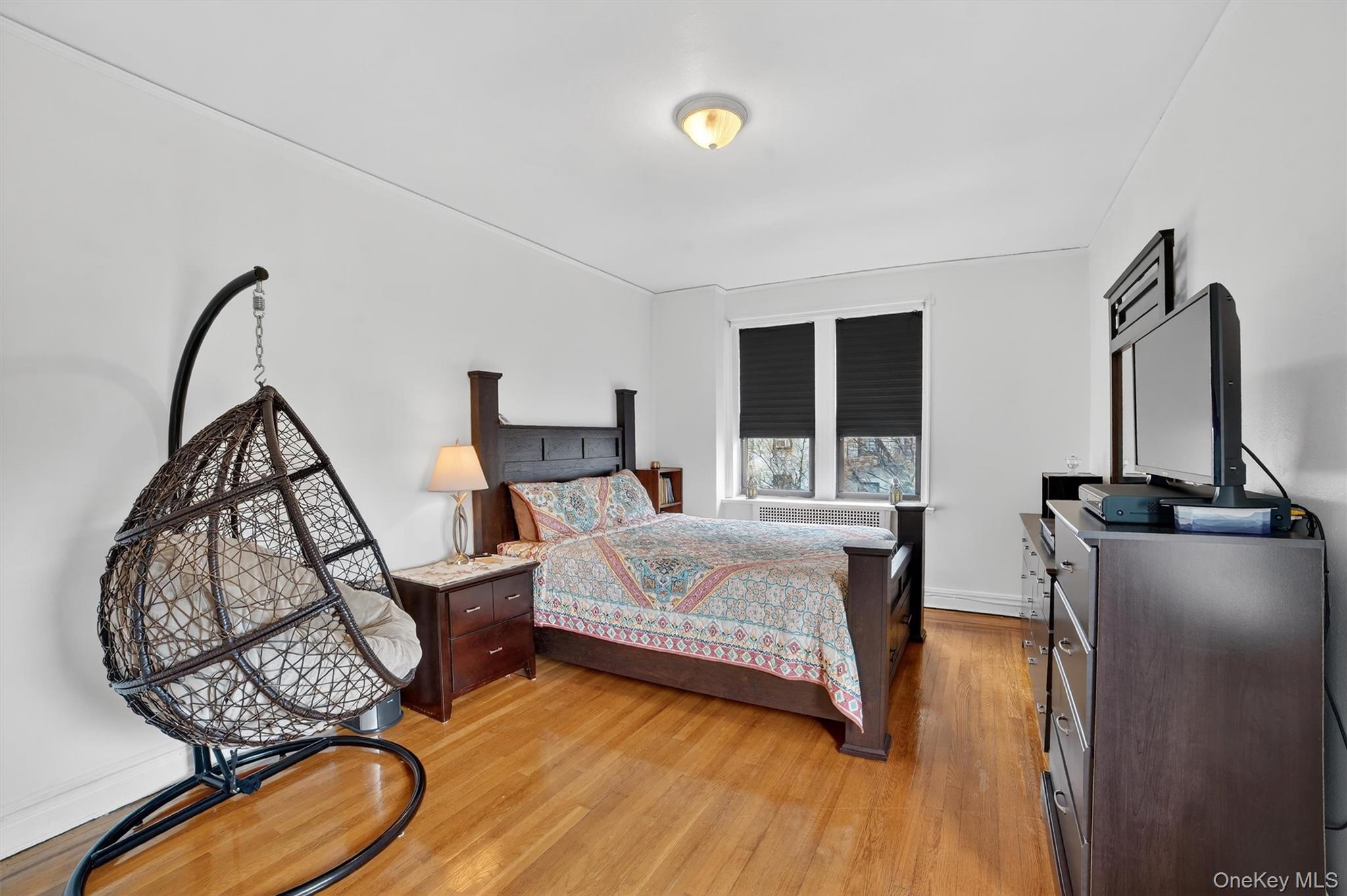 2962 Decatur Avenue, Unit 5 Bronx, NY 10458 - Photo 11 of 17 a bedroom with a bed and wooden floor