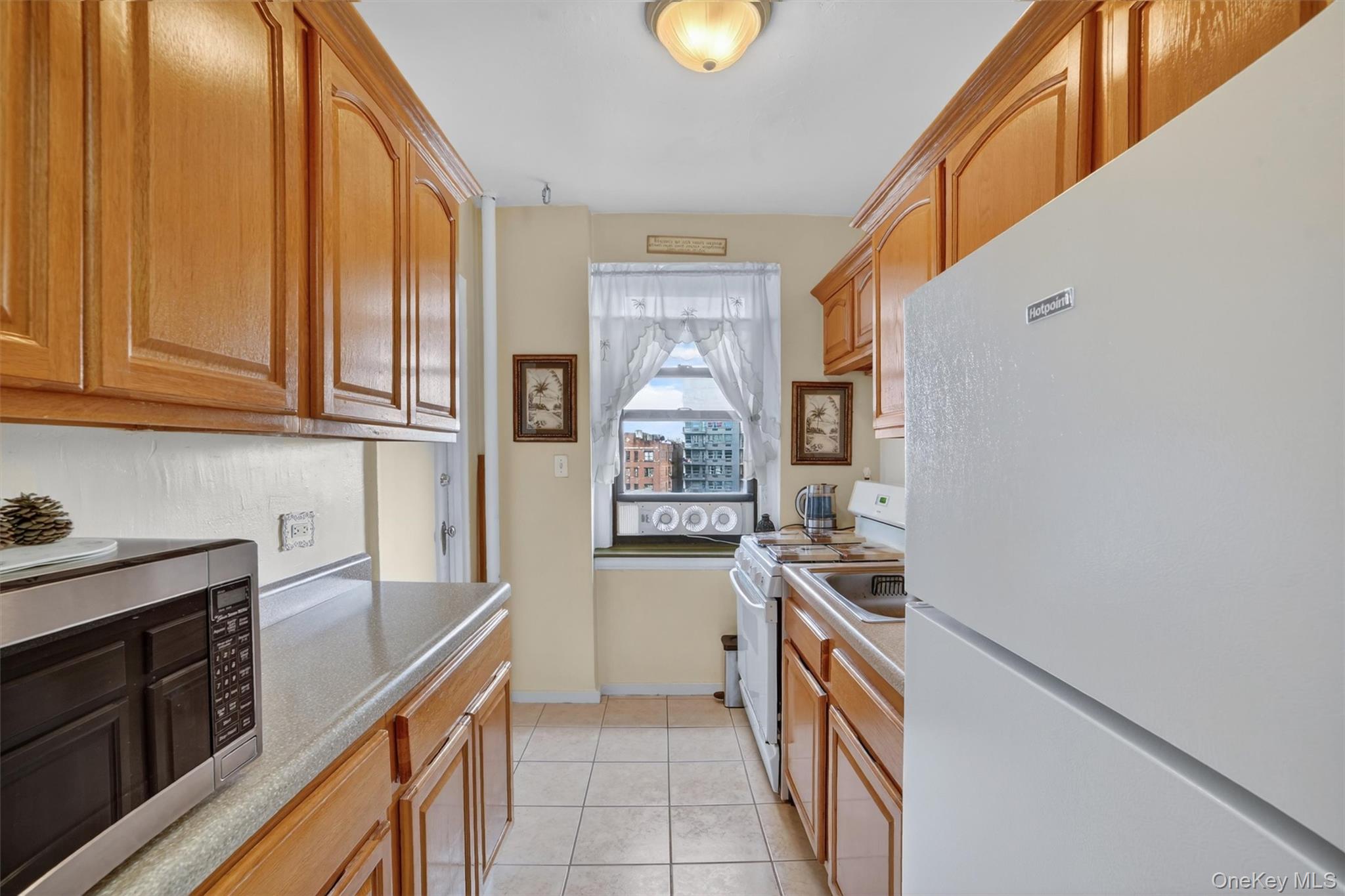 2962 Decatur Avenue, Unit 5 Bronx, NY 10458 - Photo 3 of 17 a kitchen with stainless steel appliances granite countertop a stove and a sink