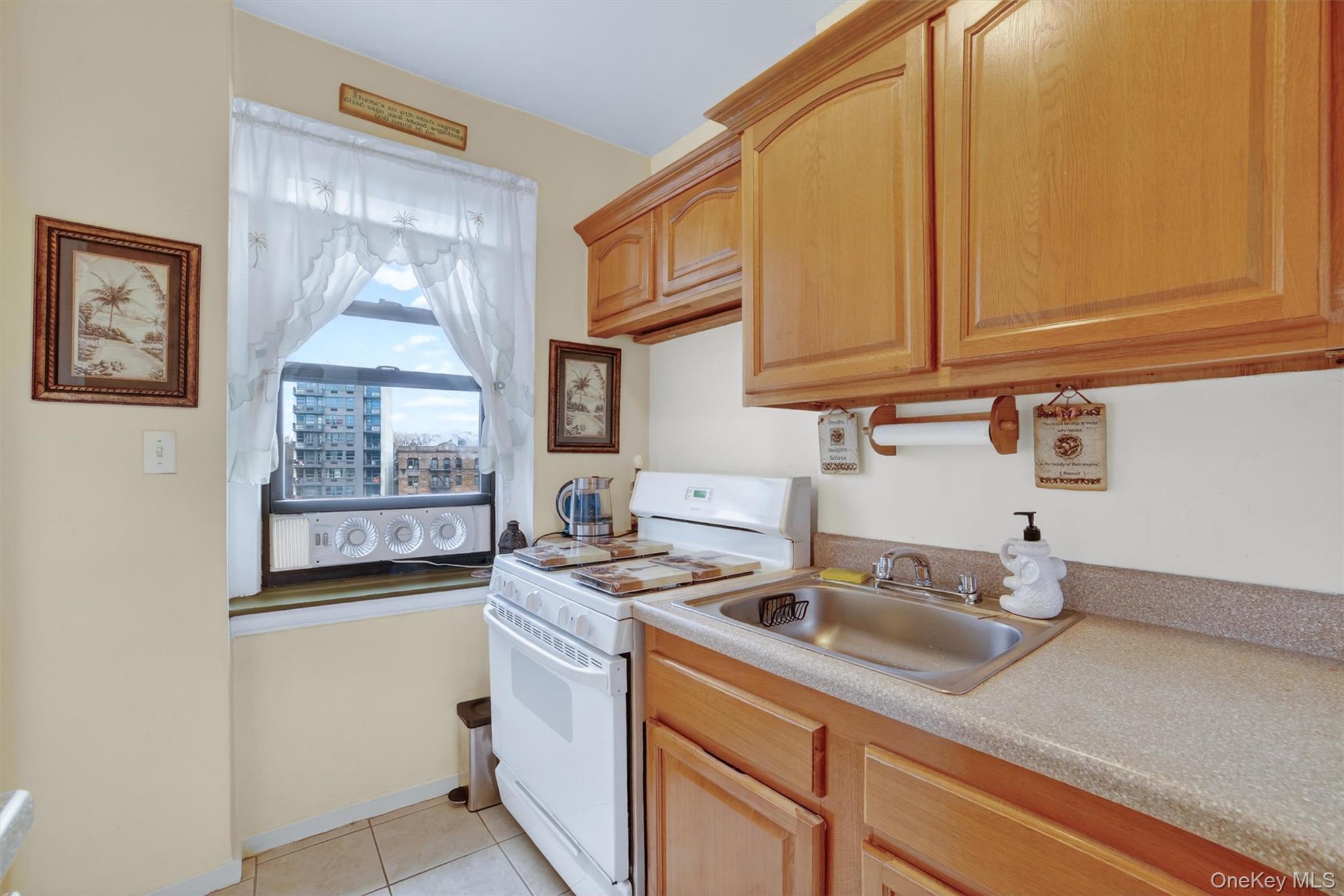 2962 Decatur Avenue, Unit 5 Bronx, NY 10458 - Photo 4 of 17 a kitchen with stainless steel appliances granite countertop a sink stove and cabinets