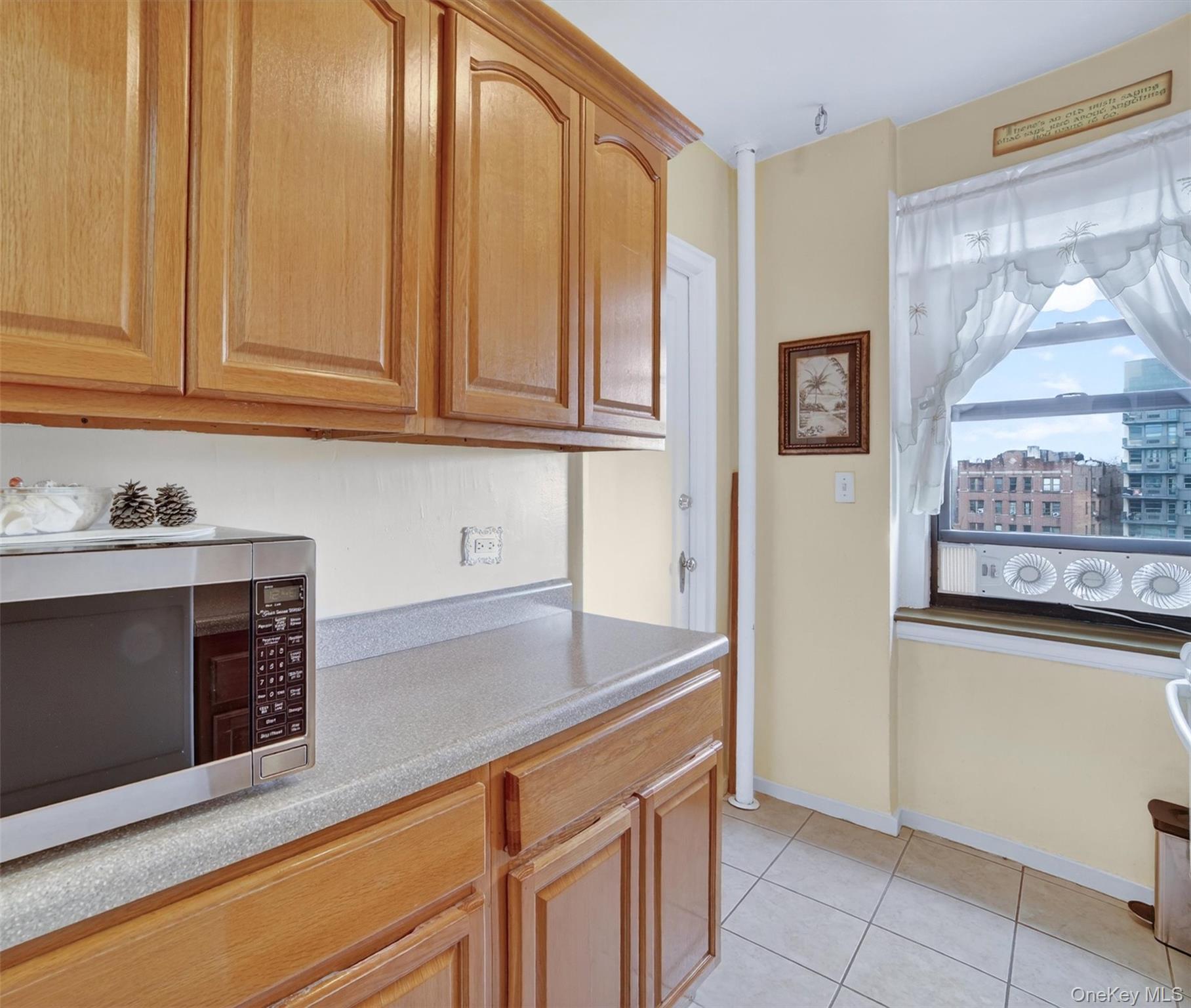 2962 Decatur Avenue, Unit 5 Bronx, NY 10458 - Photo 5 of 17 a kitchen with granite countertop cabinets stainless steel appliances and a counter space