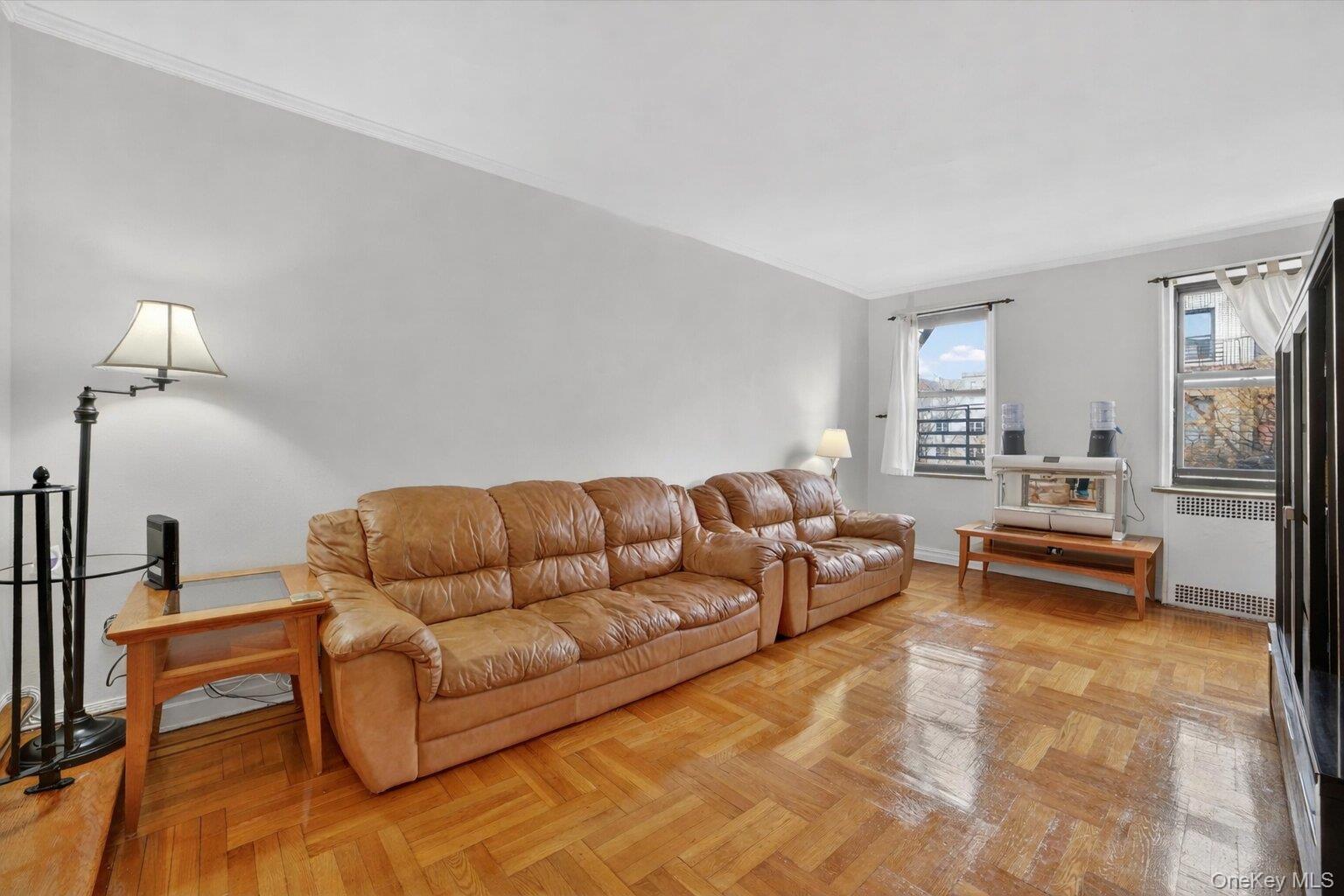 2962 Decatur Avenue, Unit 5 Bronx, NY 10458 - Photo 8 of 17 a living room with furniture and a lamp