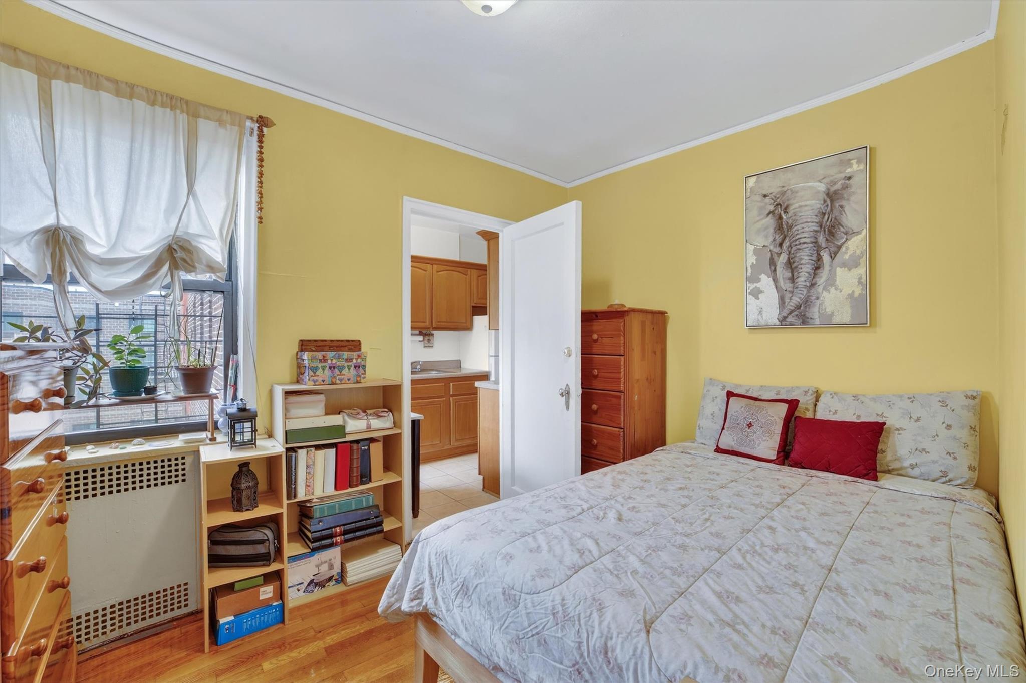 2962 Decatur Avenue, Unit 5 Bronx, NY 10458 - Photo 10 of 17 a bedroom with a bed and a book shelf