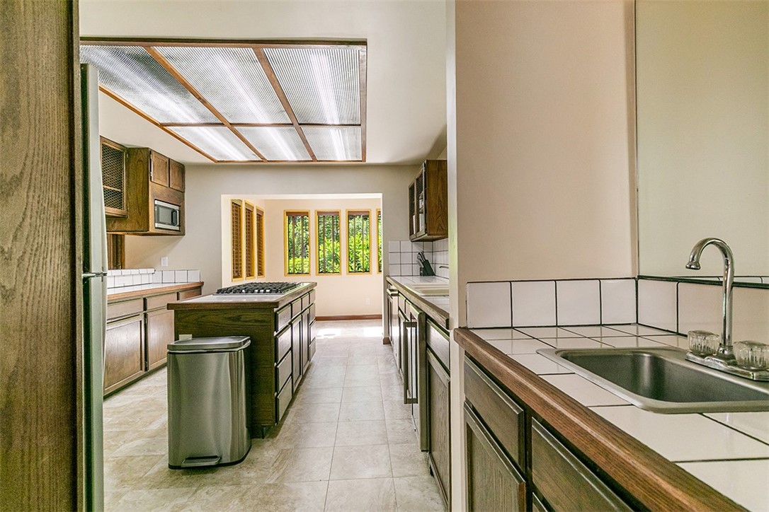 760 Kuffel Canyon Road Lake Arrowhead, CA 92385 - Photo 12 of 24 a kitchen with a stove sink and cabinets
