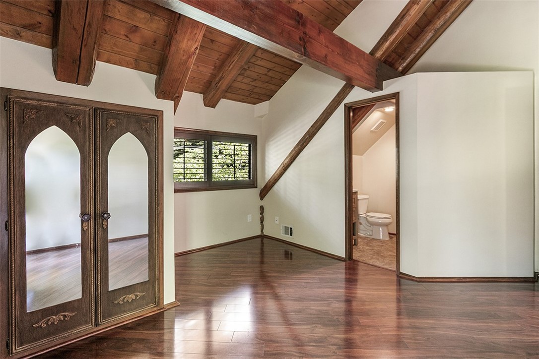 760 Kuffel Canyon Road Lake Arrowhead, CA 92385 - Photo 16 of 24 a view of empty room with wooden floor and fan