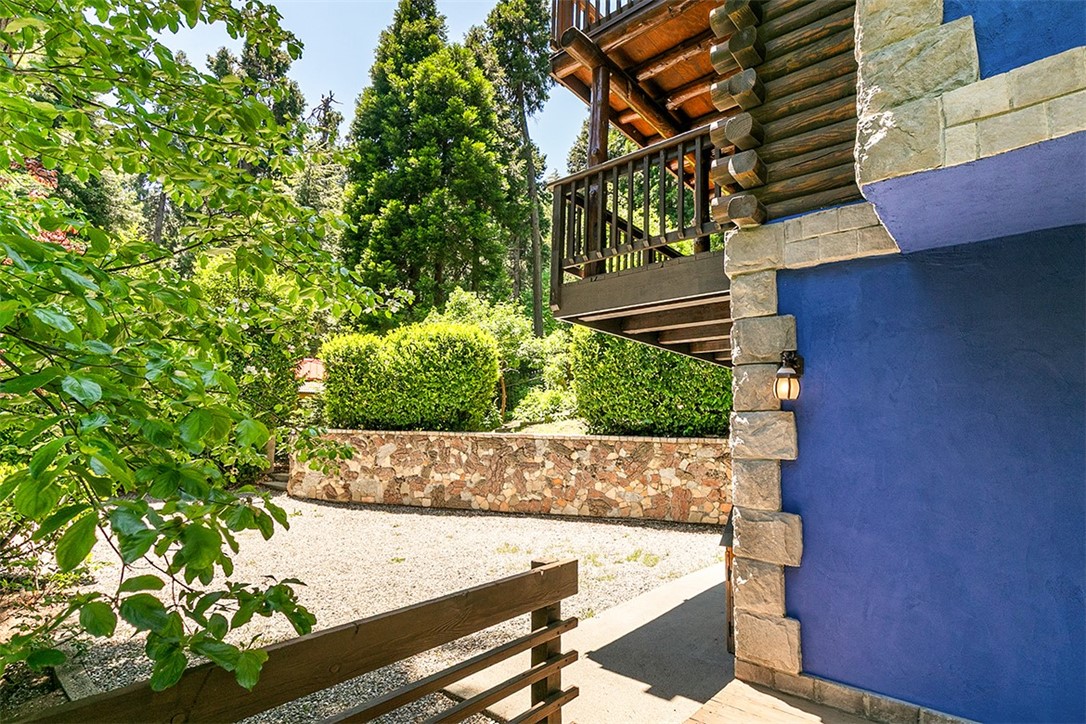 760 Kuffel Canyon Road Lake Arrowhead, CA 92385 - Photo 2 of 24 a view of a house with a yard and sitting area