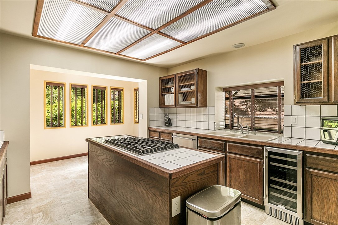 760 Kuffel Canyon Road Lake Arrowhead, CA 92385 - Photo 7 of 24 a kitchen with a stove sink and cabinets