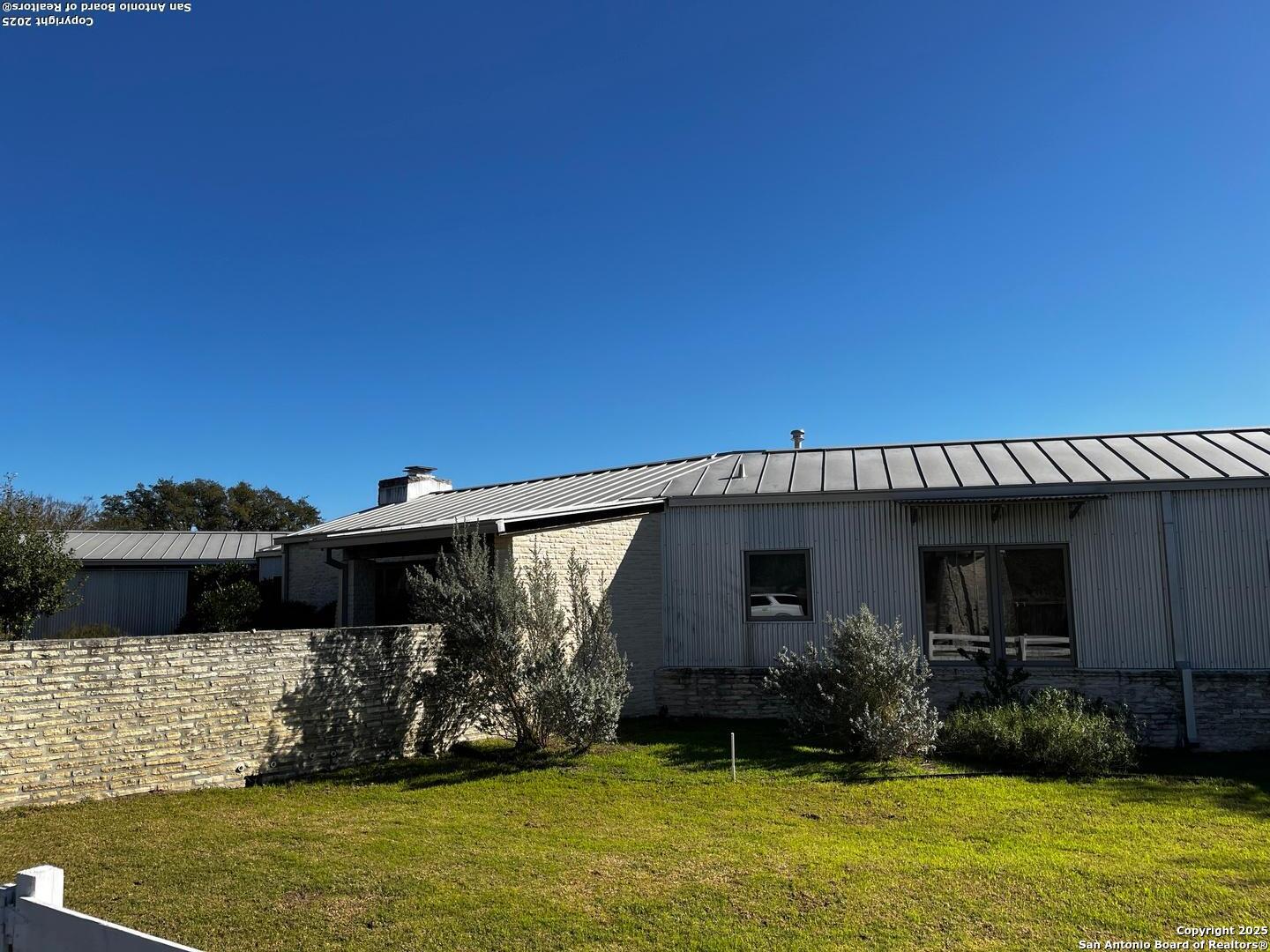 205 Crabapple Road Kendalia, TX 78027 - Photo 8 of 9 a view of a house with patio next to a yard