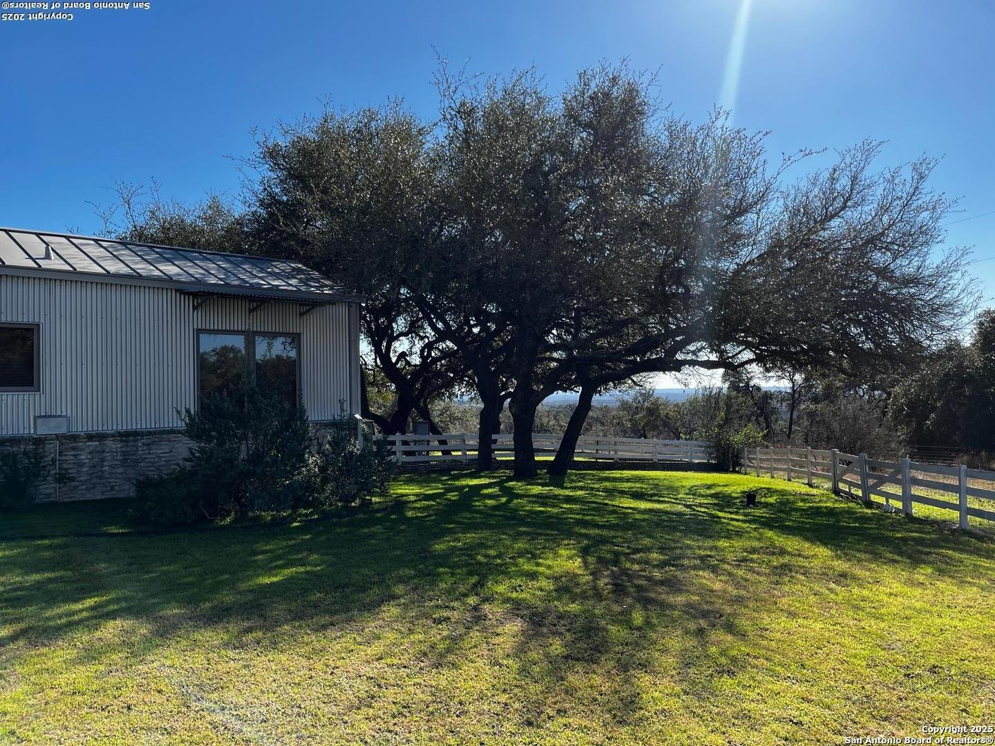 205 Crabapple Road Kendalia, TX 78027 - Photo 9 of 9 a backyard of a house with lots of green space