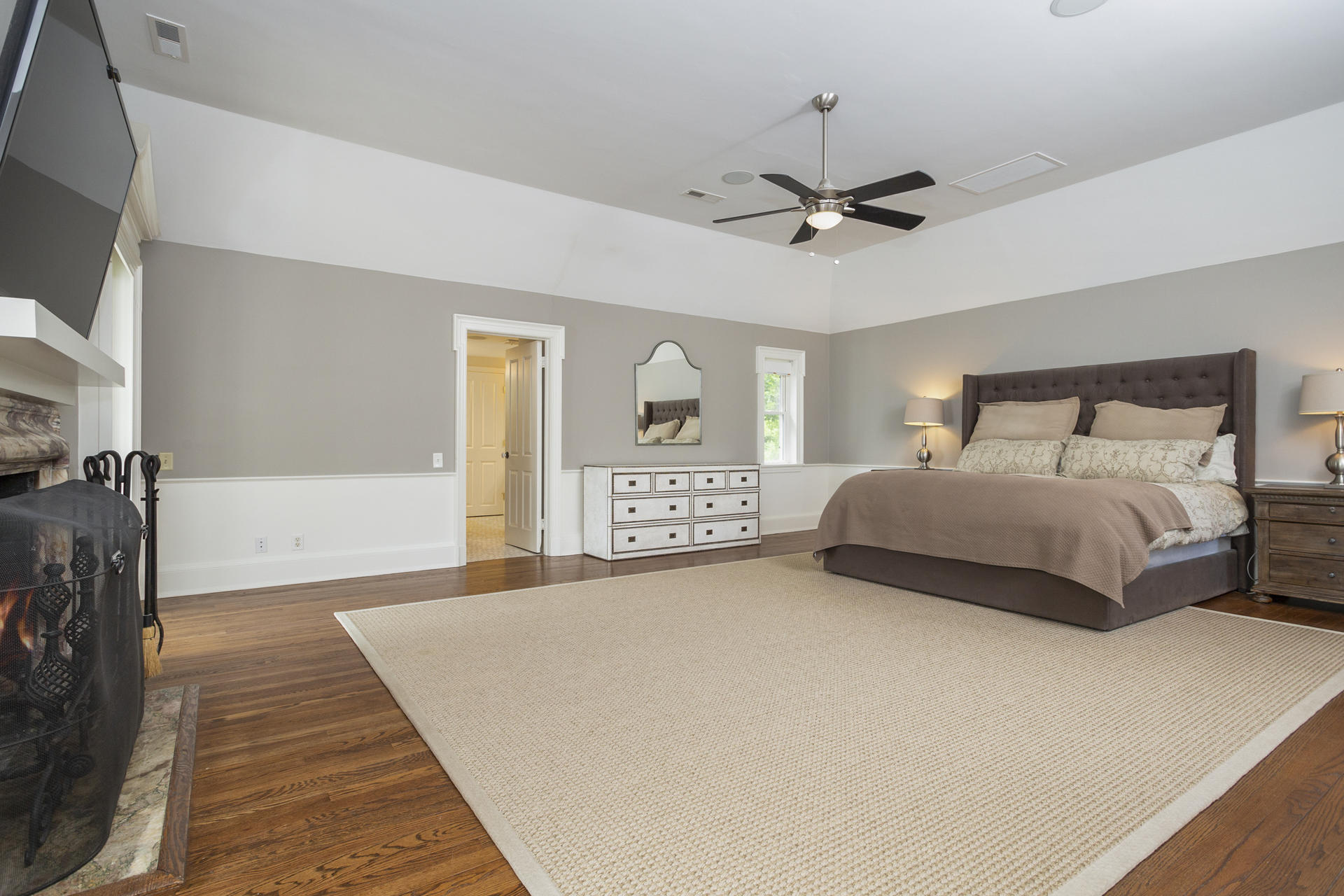 6 Woodland Road Norwalk, CT 06854 - Photo 31 of 47 a bedroom with a large bed and a chandelier