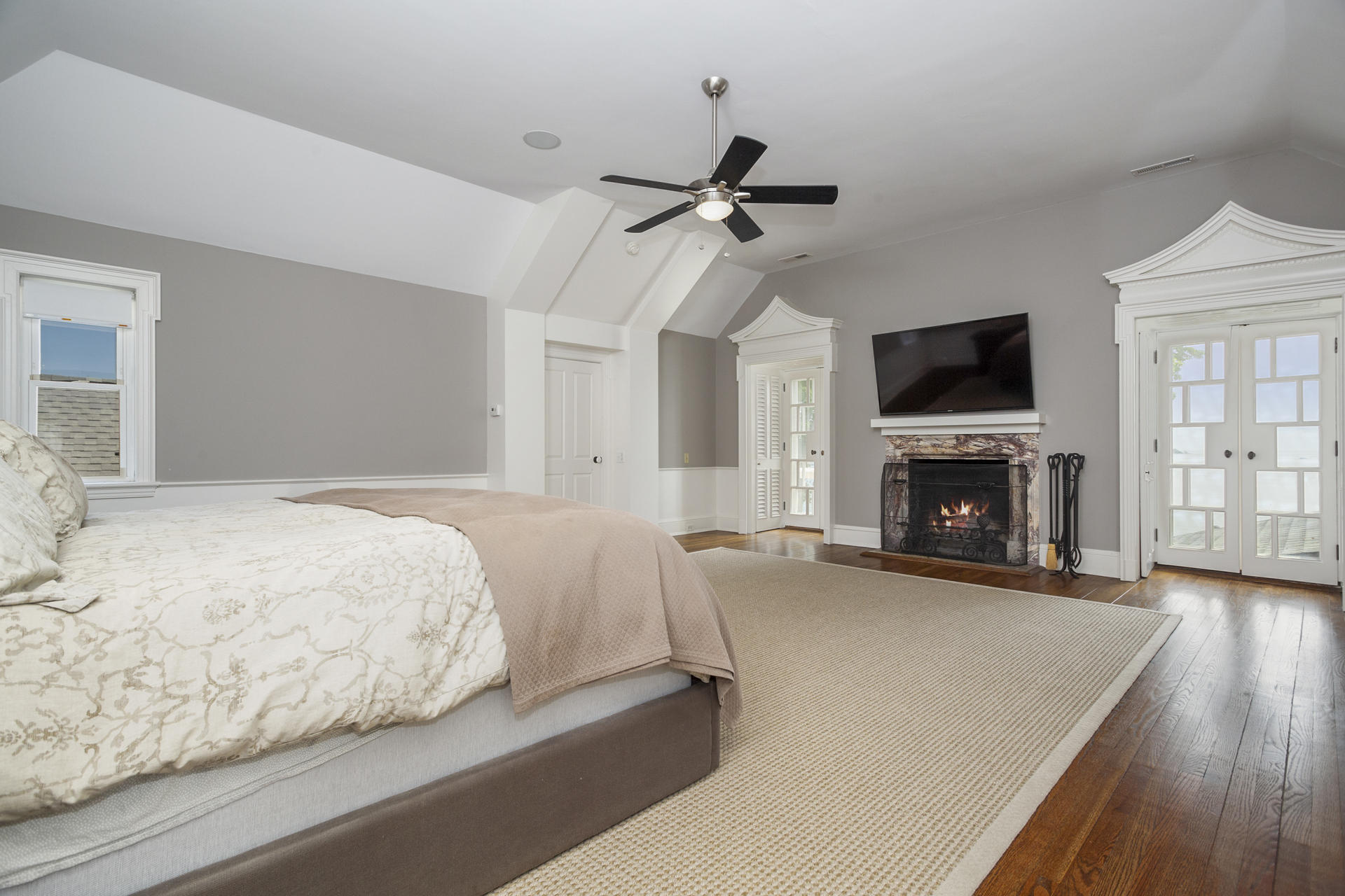 6 Woodland Road Norwalk, CT 06854 - Photo 32 of 47 a spacious bedroom with a bed and a fireplace