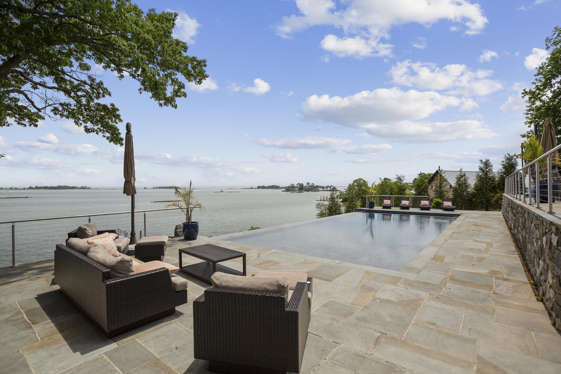 6 Woodland Road Norwalk, CT 06854 - Photo 6 of 47 a view of roof deck with couches and sky view