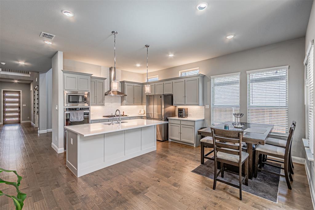 13237 Jonata Street Frisco, TX 75035 - Photo 15 of 39 a large kitchen with a table and chairs