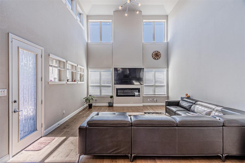 13237 Jonata Street Frisco, TX 75035 - Photo 16 of 39 a living room with a couch and a flat screen tv
