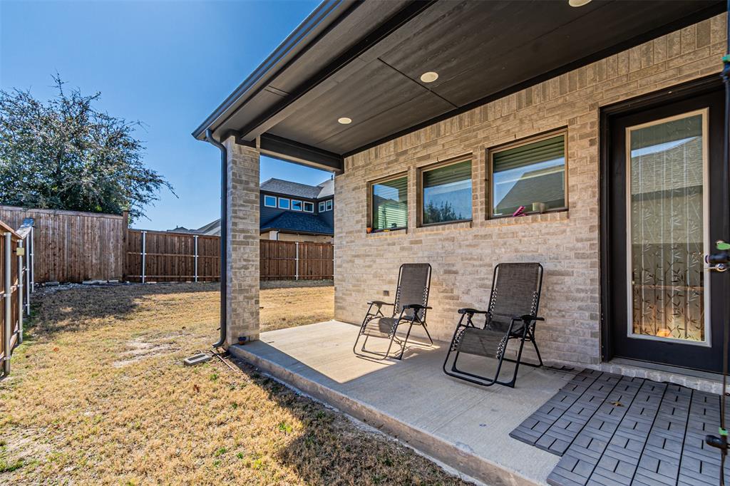 13237 Jonata Street Frisco, TX 75035 - Photo 35 of 39 a patio with table and chairs and wooden fence
