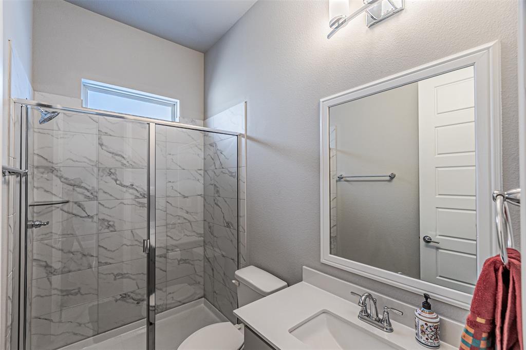 13237 Jonata Street Frisco, TX 75035 - Photo 8 of 39 a bathroom with a granite countertop sink toilet and shower