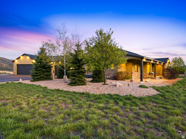 402 Shadow Hill Road Wanship, UT 84017 - Photo 4 of 90 View of front of property with stucco siding, a yard, an attached garage, and driveway